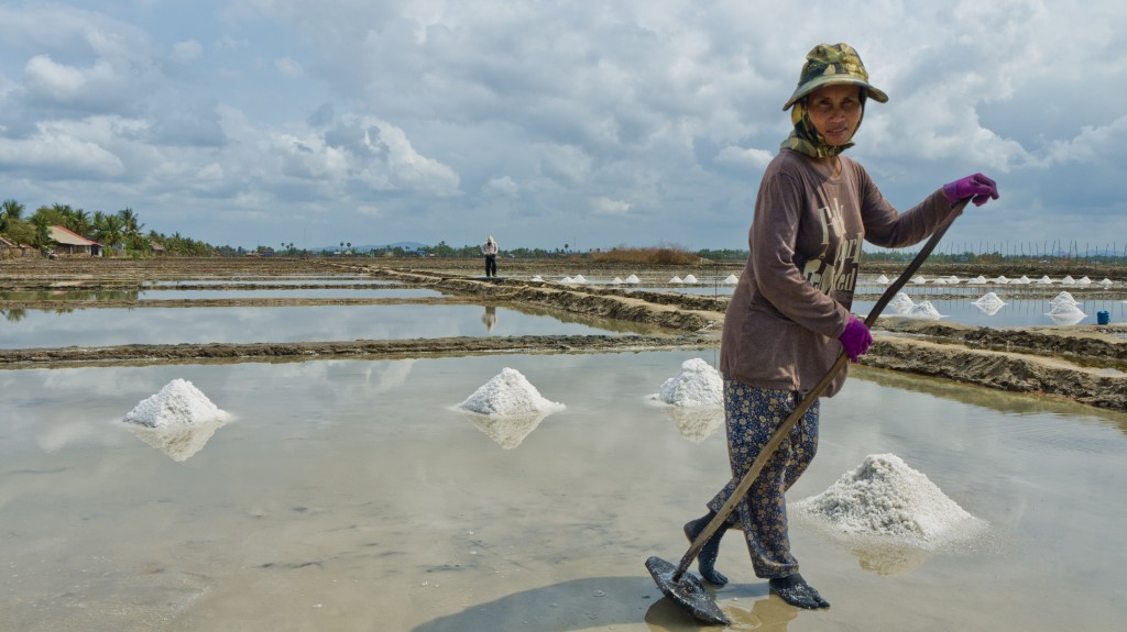 Woman working the salt fields in Kampot.